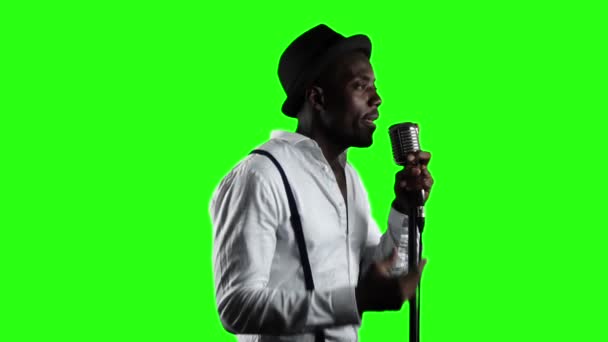 Man singer in half of the turnover sings into a microphone and dance. Green screen. Slow motion. Close up — Stock Video