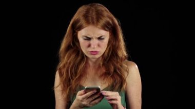 Kız ona telefon fotoğraf bakar. Siyah arka plan. Ağır çekim