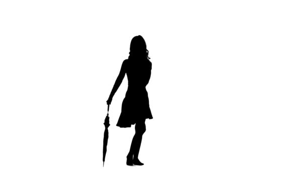 Girl with an umbrella in her hands is dancing. White background. Silhouette — Stock Video