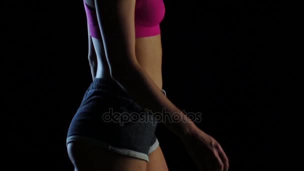 Woman walks athletic step on a black screen. Slow motion. Close up — Stock Video