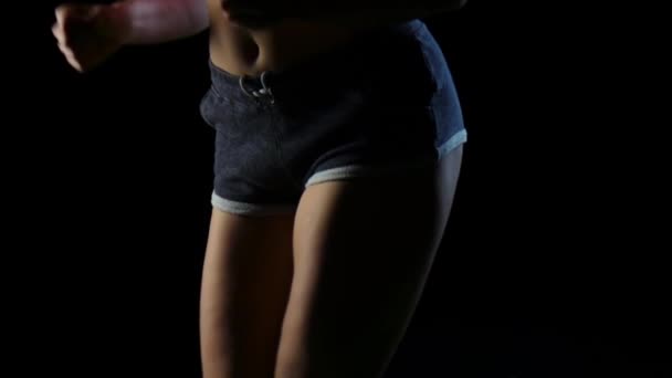 Langsames Schießen von unten nach oben selbstbewusst rennende Fitness-Frau auf schwarzem Hintergrund. Zeitlupe. Nahaufnahme — Stockvideo