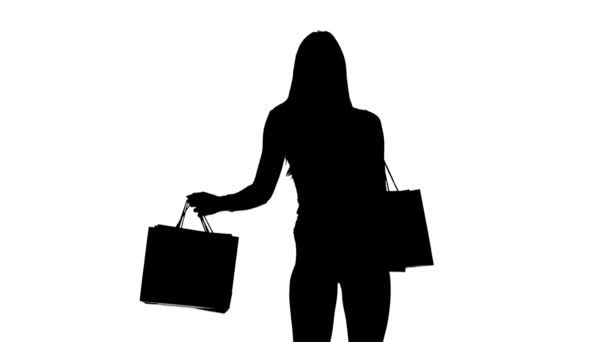 Girl with packages in hands posing for cameras. Silhouette. White background — Stock Video