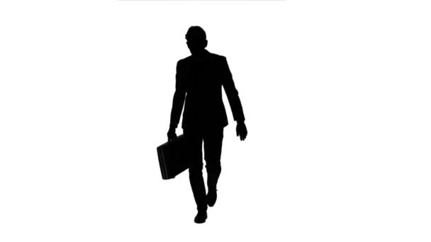 Man holds a briefcase in his hand, he rushes over it. White background. Silhouette — Stock Video