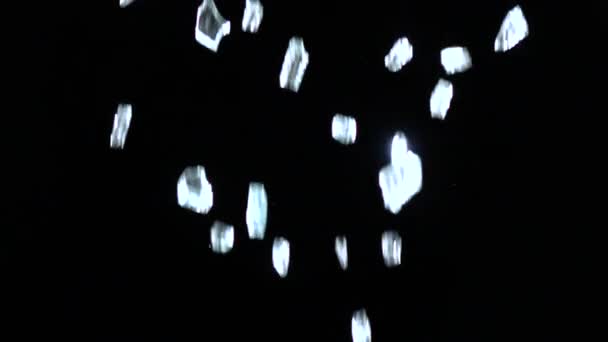 Precious stones falling on the floor in a dark room. Black background . Slow motion — Stock Video