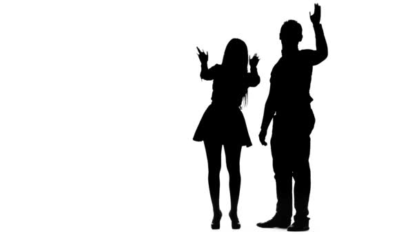 Couple in love waving their friends and calling them to them. Silhouette. White background — Stock Video