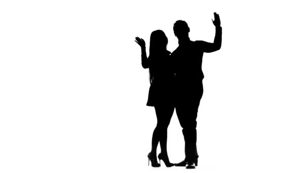 Couple in love is waiting for friends and waving at them. Silhouette. White background — Stock Video