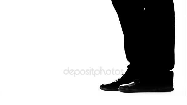 Legs of a mans girl get on toes. Silhouette. White background. Close up — Stock Video