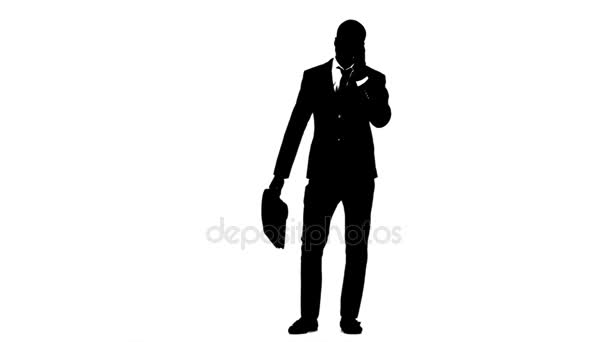 Man holds a briefcase and speaks on the phone. White background. Silhouette — Stock Video