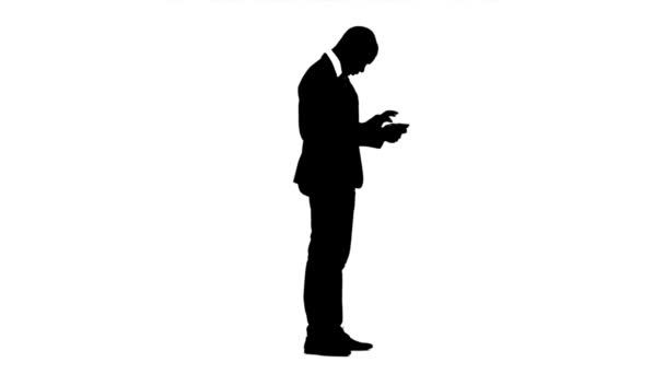 Businessman thinks his profit on a calculator. White background. Silhouette — Stock Video