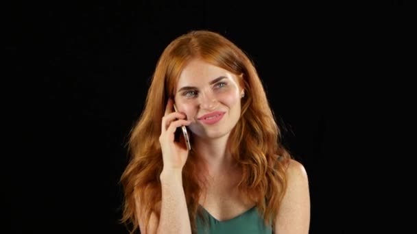 Girl talking on the phone. Black background — Stock Video