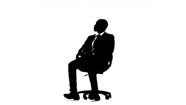 Businessman sitting in an armchair and thinking about his promotions White background. Silhouette — Stock Video