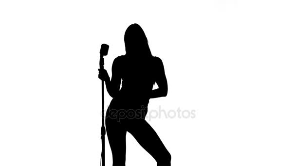 Singer is sexually moving in the frame with a retro microphone. Silhouette. White background — Stock Video