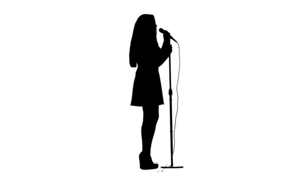 Woman sings lyrical songs and dances. White background. Silhouette. Side view — Stock Video