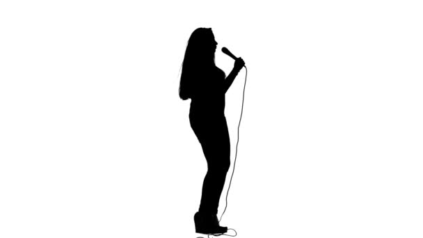 Singer dances to the beat of her song. White background. Silhouette. Side view. Slow motion — Stock Video