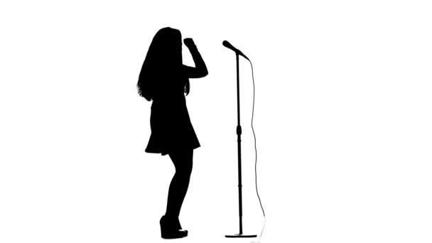 Singer dances to the beat of her song. White background. Silhouette. Side view. Slow motion — Stock Video