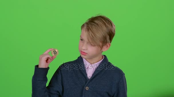 Tonåring med ett chip i handen av viftade hans huvud negativt och handen på en grön skärm — Stockvideo