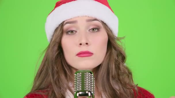 Snow maiden sings in a retro microphone and dances with energetic music. Green screen. Close up — Stock Video
