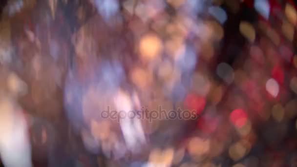 Desenfoque manchas de luces en forma de corazones bajo el oropel de Navidad. Fondo de Bokeh — Vídeos de Stock