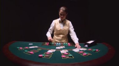 Casino Bayi otopsi yeşil masada poker oynamaya flop üç kartları. Siyah arka plan. Ağır çekim