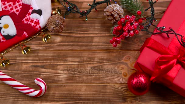 Different New Years toys sweets and flowers lie on the table. Top view — Stock Video