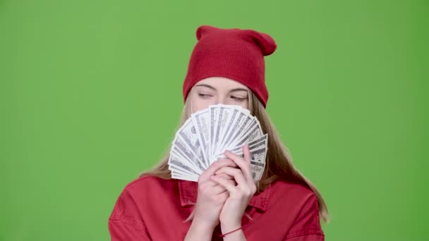 Teen is holding paper money in her hands. Green screen. Slow motion — Stock Video