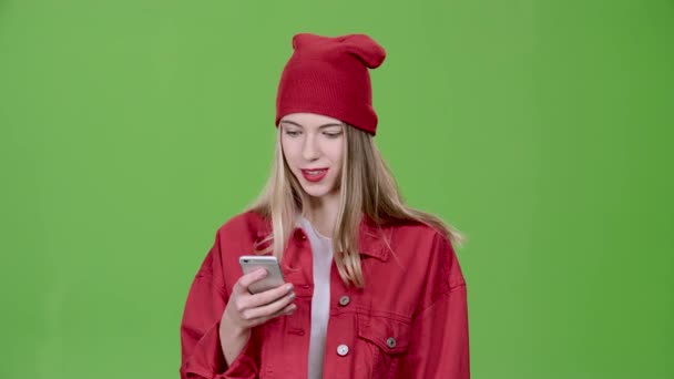 Tiener wordt een bericht afgedrukt op de telefoon. Groen scherm. Slow motion — Stockvideo