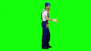 Foreman bir kask ve eldiven telefonda konuşuyor. Yeşil ekran. Yan görünüm