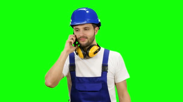 Builder speaks on the phone with his boss. Green screen — Stock Video