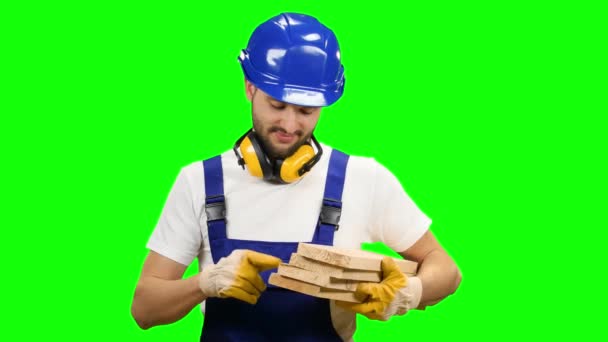 Builder holds the wooden boards in his hands and smiles. Green screen — Stock Video