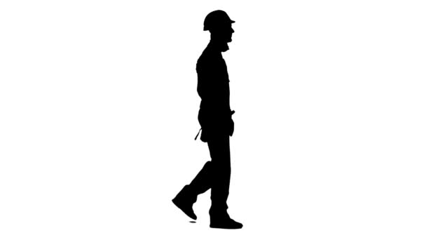 Der Mann, der von einer Baustelle kommt, hat einen Bohrer in der Hand. weißer Hintergrund. Silhouette. Seitenansicht — Stockvideo