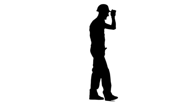 Bauarbeiter geht und winkt seinen Arbeitern zu und zeigt den Daumen nach oben. weißer Hintergrund. Silhouette. Seitenansicht — Stockvideo