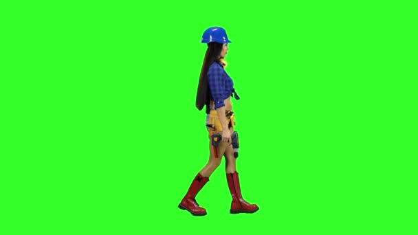 Menina em um capacete e com fones de ouvido no pescoço vai para o lado em um fundo verde — Vídeo de Stock