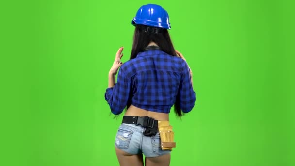 Rear view of girl booty dancing in a green background — Stock Video