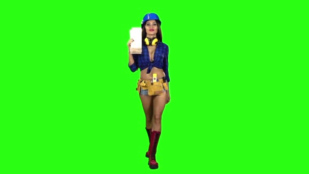 Menina em shorts capacete azul com as tábuas em seus ombros caminha em um fundo verde. Movimento lento — Vídeo de Stock