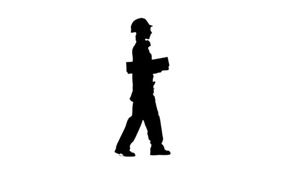 Construction worker wearing a helmet carries three wooden boards. Silhouette. White background. Side view — Stock Video