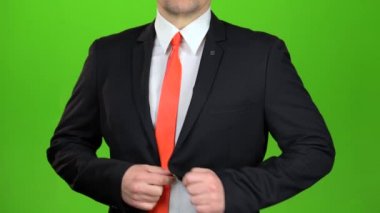 Onun ceket ve kravatını bağcıklı işadamı upzips. Yeşil ekran. Yakın çekim