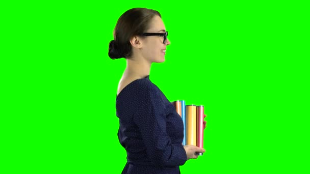 Student goes to school with books in her hands. Green screen. Side view — Stock Video