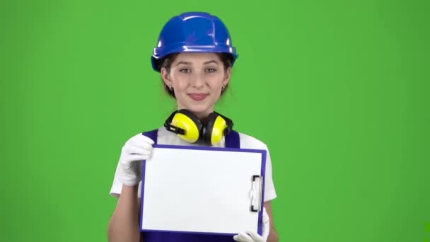 Engineer in a hard hat and safety raises the paper plate . Green screen. Close up. Slow motion — Stock Video