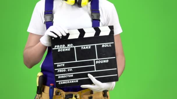 Hands of the builder girl keep the cracker. Green screen. Close up. Slow motion — Stock Video