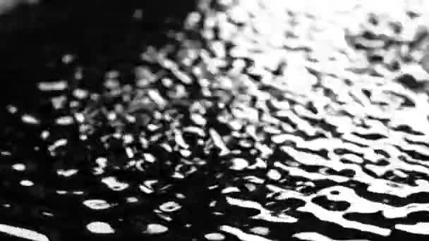 Light and bubbling water under the influence of ultrasound. Black background. Slow motion — Stock Video