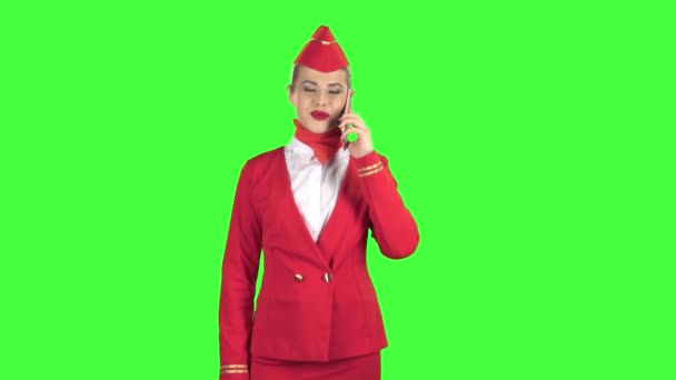 Stewardess beszél a telefonon, és a lépés, a távolba. Zöld képernyő. — Stock videók