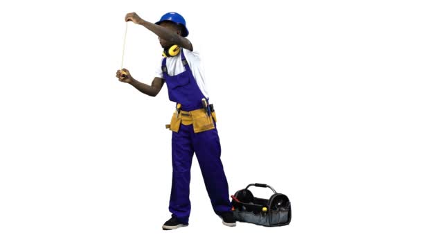 Builder african american takes measurements with a yellow tape measure. Alpha channel — Stock Video