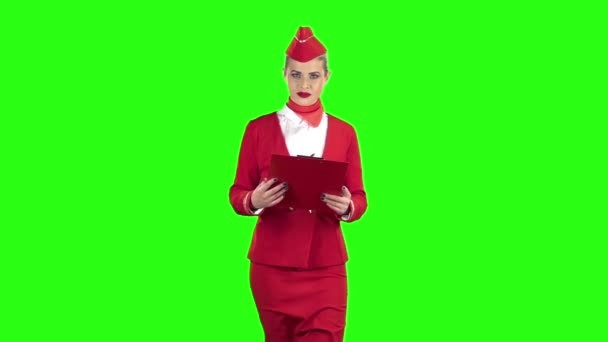 Woman steps with a red folder in her hands . Green screen. Slow motion — Stock Video