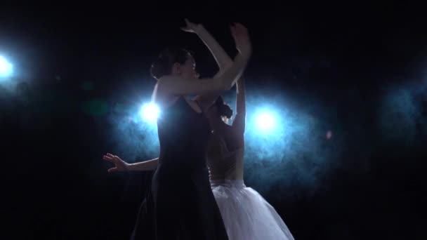 Романтические балерины в белых и черных пачках, вращающихся в танце. Закройте, замедленная съемка . — стоковое видео