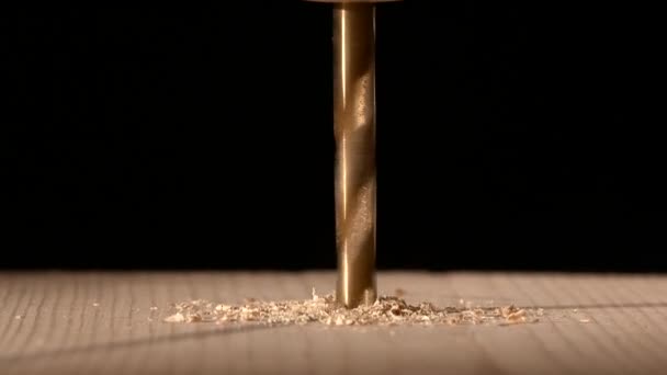 Continue drilling with sawdust on wooden plate black — Stock Video