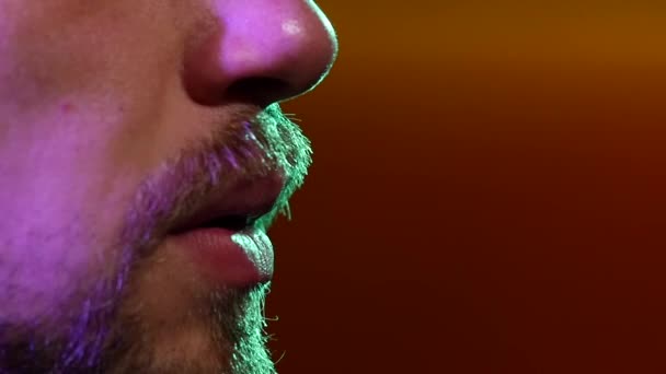 De mond van een man die shisha rookt in een restaurant. Langzame beweging. silhouet — Stockvideo