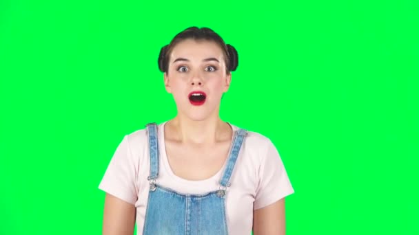 Shock girl face expression on green screen at studio, slow motion — 图库视频影像