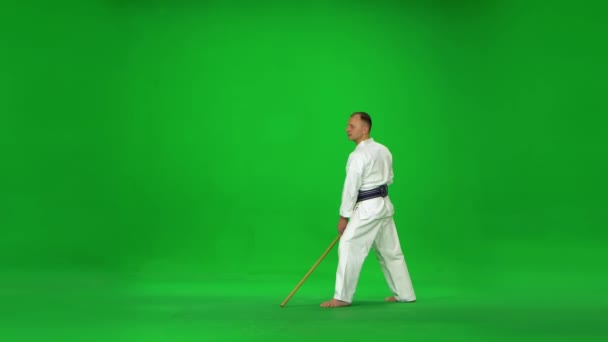 Masculino kendo mestre no branco quimono guerreiro praticando arte marcial com o bambu bokken no verde tela . — Vídeo de Stock