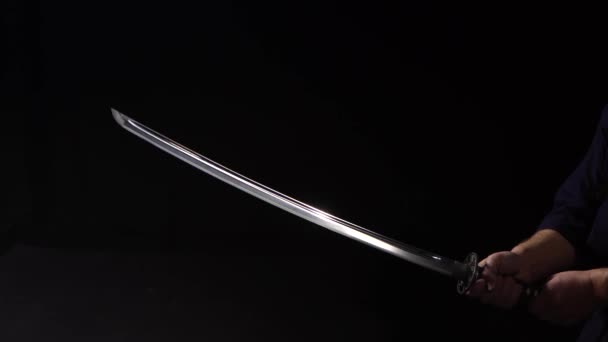 Dramatic studio shot of man holding samurai sword. Close up — Stock Video