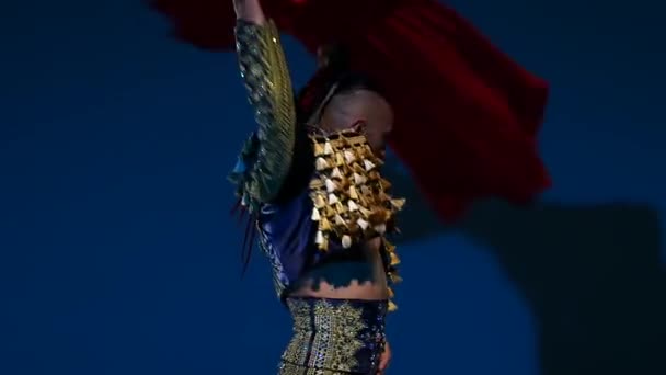 Torero in blue and gold suit or typical spanish bullfighter isolated spotlight on a blue background. Close up, slow motion. — 비디오